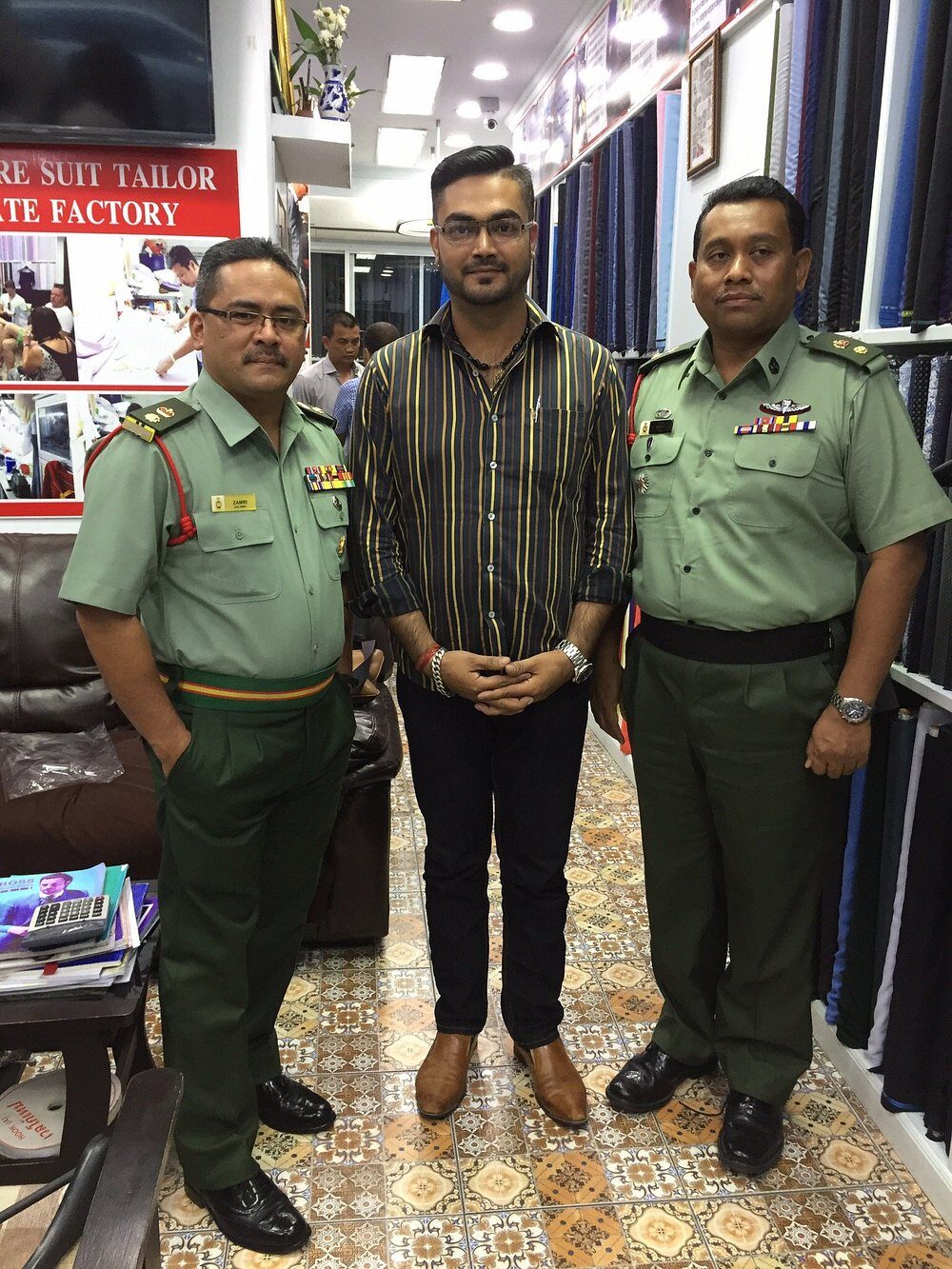 Clients visiting the shop among the cloth shelves